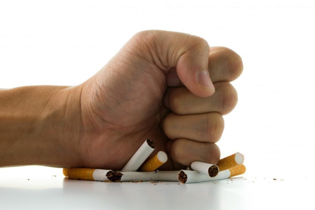 fist on cigar butts - managing cholesterol by quitting smoking